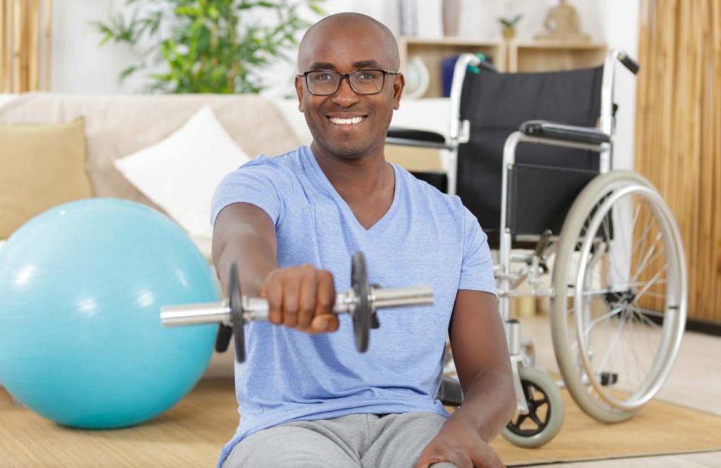 special needs man holding dumbell